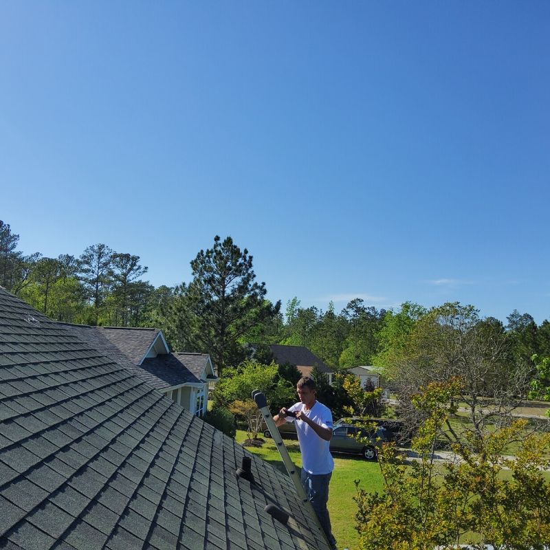 man inspecting a roof